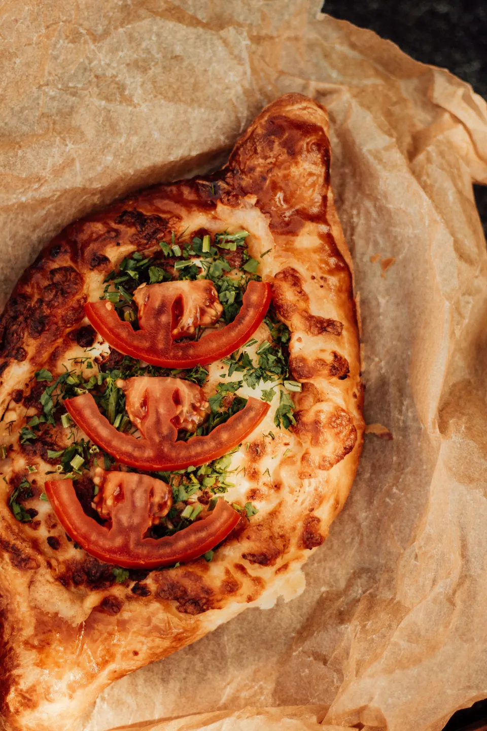 Adjarian khachapuri Georgian cheese bread with herbs and tomato