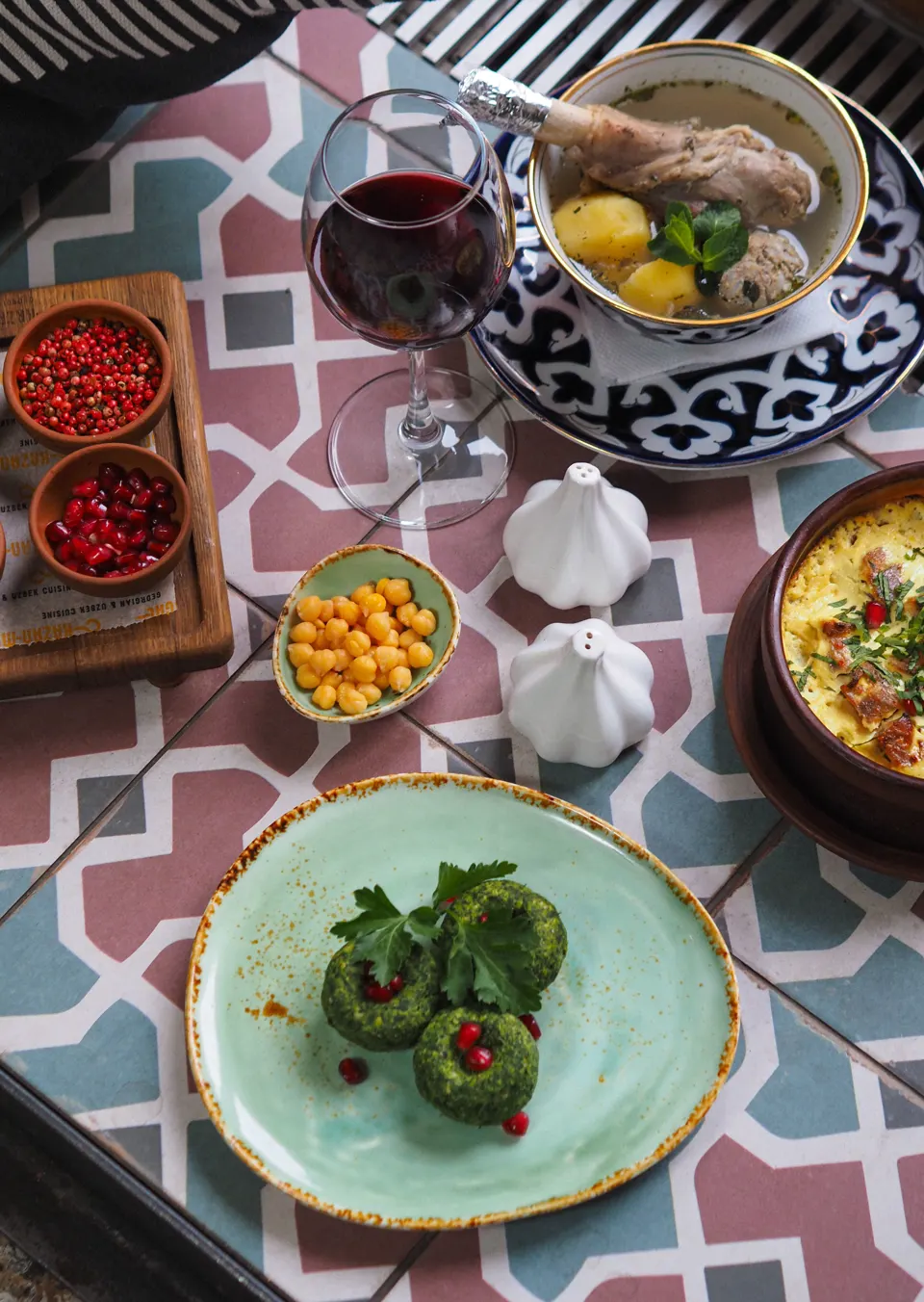 Georgian food table with pkhali, soup, wine, and traditional dishes